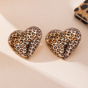 Retro vintage leopard print heart shaped stud earrings for women on beige background