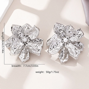 Exaggerated silver flower earrings with hammered texture and center pearl detail