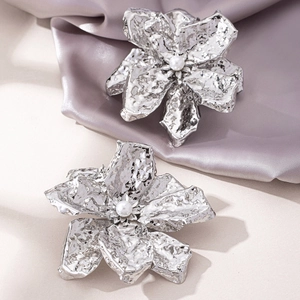 Exaggerated silver flower earrings with wrinkled metal texture and center pearl detail