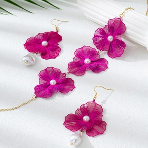 Elegantes hohlförmiges Schmuckset mit magentafarbenen Blumenohrringen und Perlenkette