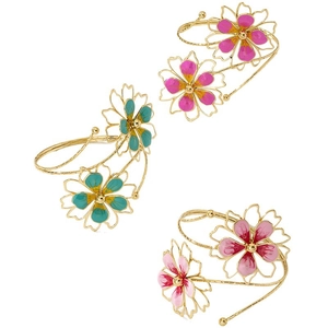 Chic gold-tone metal arm cuffs with colorful enamel flowers in pink and blue tones