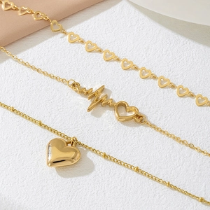 Three-layer gold-plated layered necklace with heart charms and polished beads design