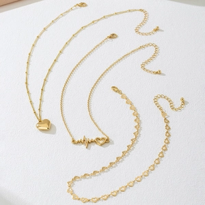 Detailed view of triple-layered golden heart necklaces with lobster clasp and extension