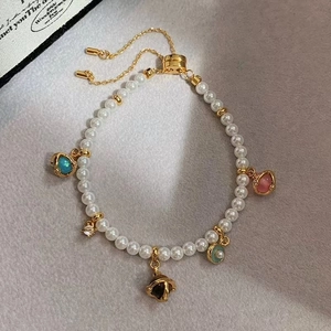 Adjustable pearl bracelet with 18k gold planetary charms and colorful gemstone beads