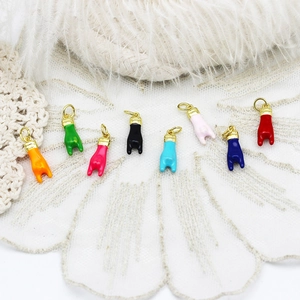 Detailed view of colorful enamel hand gesture charms for DIY necklace and jewelry making