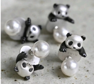 Detailed view of panda shaped pearl earrings with micro-inlaid 925 silver studs