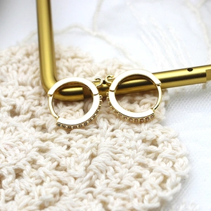 18K gold plated hoop earrings with sparkling micro-pave crystals on a display stand
