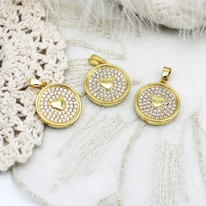 Elegant gold heart pendants with white zirconia set on a vintage lace and feather background