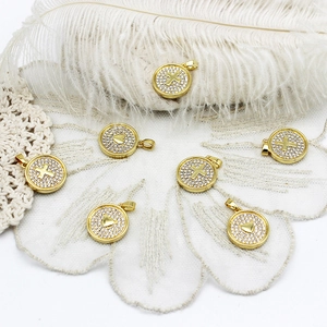 Golden round pendants with heart and cross patterns featuring cubic zirconia inlay