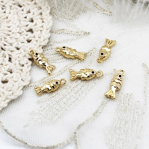 Macro shot of 18K gold plated fish charms with smooth polished finish for DIY jewelry