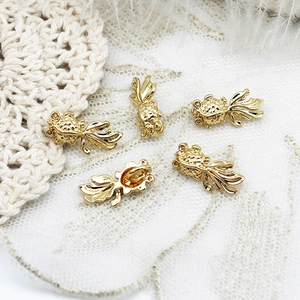 Macro view of five 18K gold-plated goldfish charms for DIY jewelry making