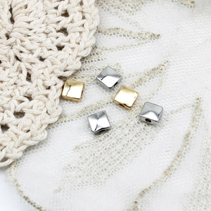 Detailed view of square gold and silver spacers for DIY jewelry necklace making