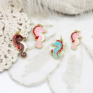 Detailed macro view of colorful enamel seahorse charms for DIY jewelry making and crafts