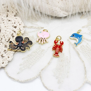 Detail of colorful enamel marine charms featuring octopus, jellyfish, lobster and dolphin