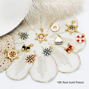 Detailed macro of 18K gold plated nautical charms like anchors and helms for DIY jewelry