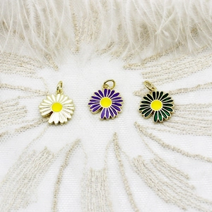 Three colorful daisy flower charms in white, purple, and green for DIY jewelry making
