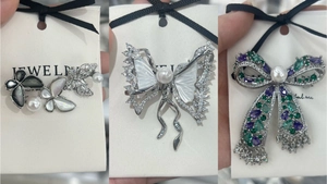 Detailed close-up of luxury butterfly brooches with shell inlay and cubic zirconia