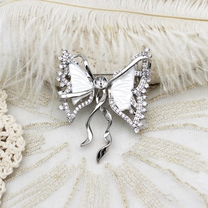 Close-up of luxury butterfly brooch with shimmering mother-of-pearl and inlaid zircon stones