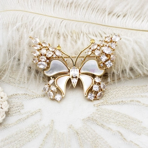 Elegant butterfly brooch with natural mother of pearl and cubic zirconia on gold metal