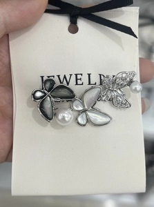 Detailed close-up of luxury butterfly brooch with natural mother of pearl and zircon stones