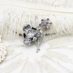 Macro shot of lily of the valley brooch with inlaid cubic zirconia and pearl petals
