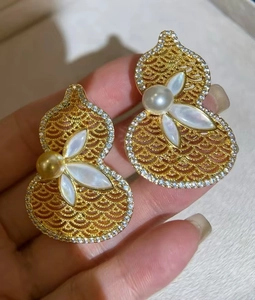 Detail of 18K gold plated gourd pendant with hollow mother of pearl and zircon stones