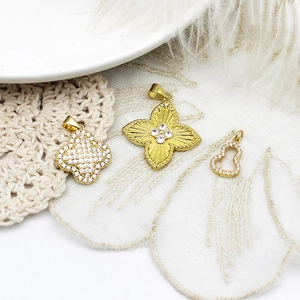 Three 18K gold plated clover and gourd charms with micro-set zircon on white texture