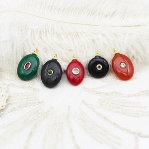 Detailed view of colorful geometric natural stone pendants on elegant white lace background