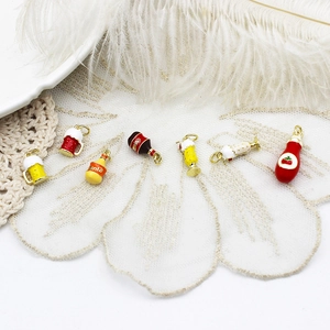 Detailed view of colorful enamel soda and beverage bottle charms for DIY jewelry