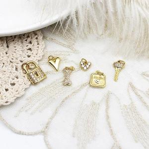 Micro-pave zircon heart and padlock pendant charms in 18k gold-plated finish