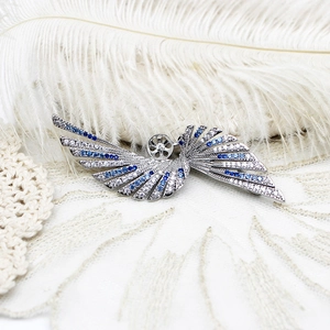 Detail view of butterfly pin setting with blue gradient stones and pearl base