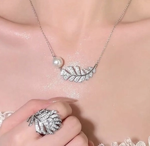 Détail du parure collier et bague plume en argent avec zircons micro-pave et perles blanches