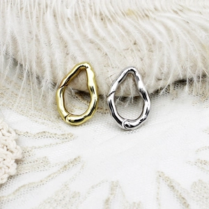 Macro detail of 18k gold and silver irregular geometric jewelry clasps with wavy texture