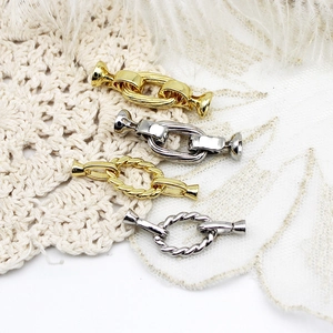 Detailed macro view of 18k gold plated twisted and smooth DIY jewelry connector clasps