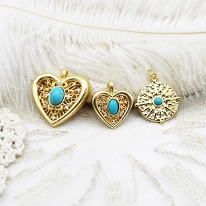 Detailed macro view of vintage turquoise heart and round gold DIY jewelry pendants