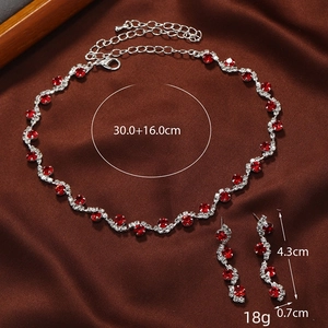 Elegant red rhinestone necklace and earrings set on premium brown silk background