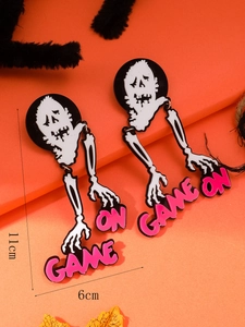 Macro shot of Halloween skeleton dangle earrings with pink GAME ON lettering and size details