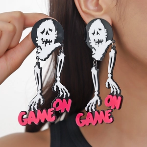 Detailed close-up of acrylic skeleton earrings with pink Game On letter charms