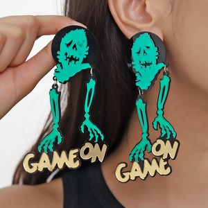 Macro detail of oversized acrylic Halloween skeleton earrings with GAME ON text