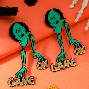 Gothic skull earrings with green zombie head and Game On text for Halloween party look