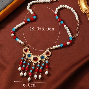 Detail of vintage Chinese collar necklace with colorful beads and pearl tassels