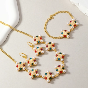 Macro view of gold jewelry set with colorful crystals and pearls for evening wear