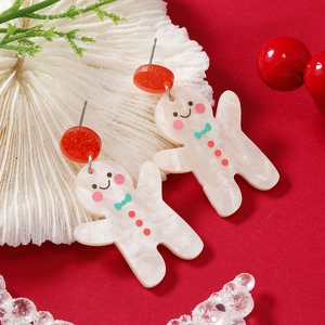 Festive gingerbread man acrylic earrings with red glitter studs and Christmas ornaments