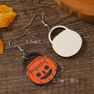 Front and back detail of wooden pumpkin earrings with dimensions on a rustic wood surface
