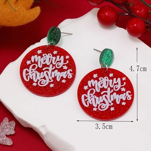 Close-up of Merry Christmas glitter acrylic earrings with red and green festive details