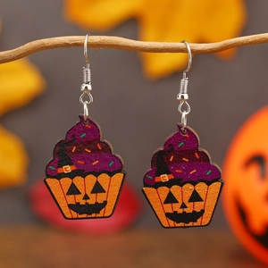 Halloween pumpkin cupcake earrings with purple glitter and witch hat on wooden branch
