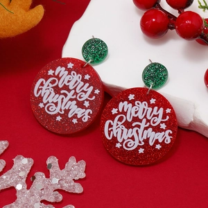 Exaggerated Christmas tree earrings with Merry Christmas text on a festive red background