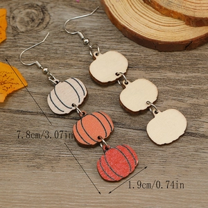 Detailed view of triple-tiered wooden pumpkin earrings with dimensions 7.8cm in length