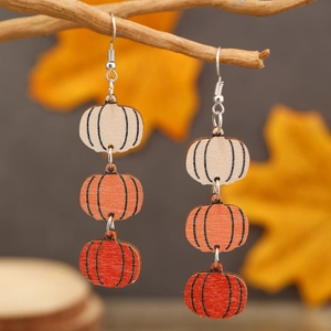 Three-tier wooden pumpkin drop earrings for Halloween in cream, orange, and autumn red colors