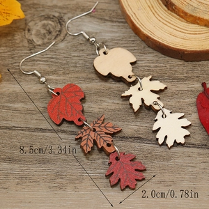 Detailed macro shot of wooden maple leaf drop earrings with precise dimensions 8.5cm